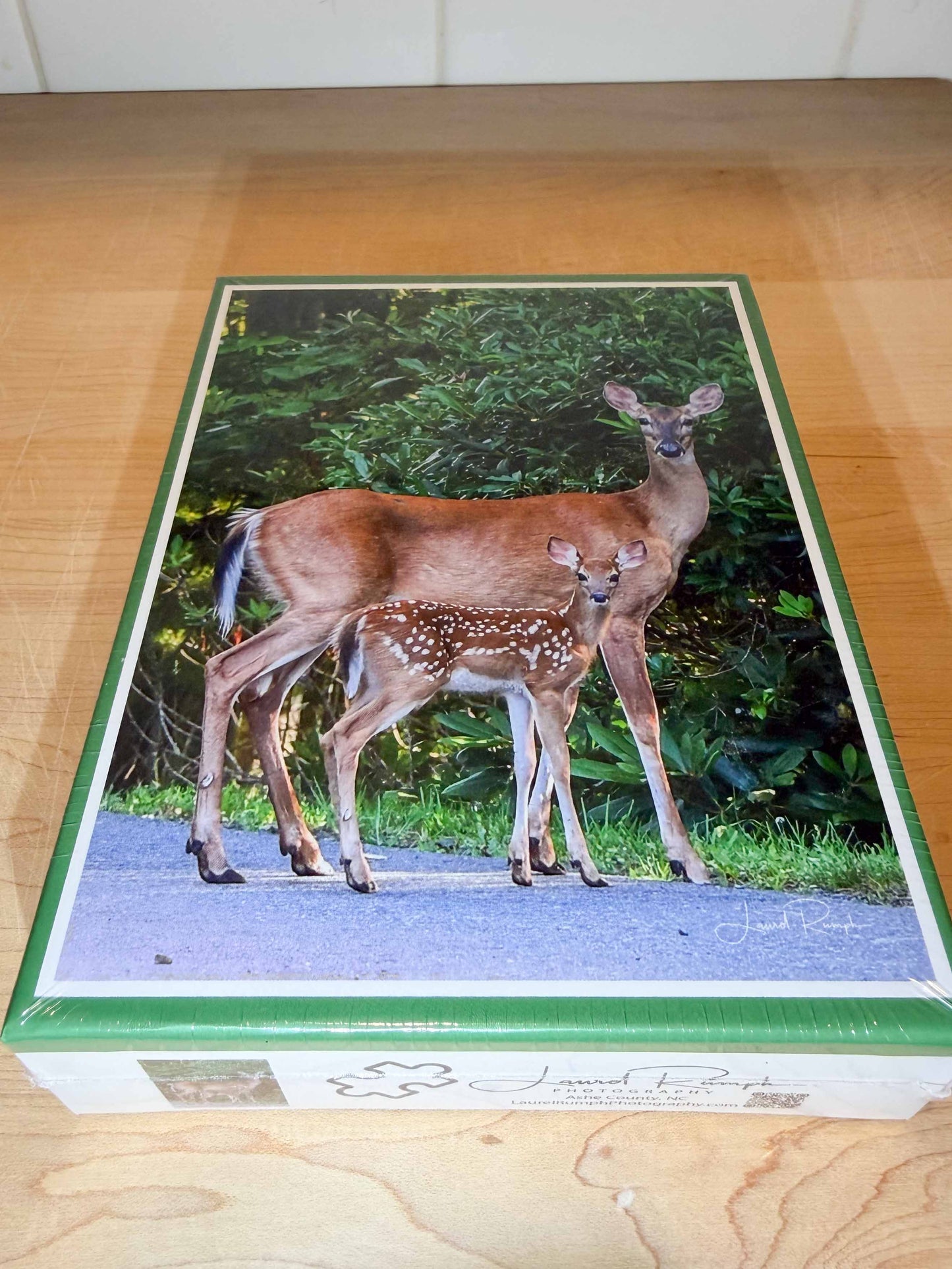 Jigsaw puzzle box featuring a deer and fawn on a road with greenery in the background, in Fleetwood (Ashe County), North Carolina.