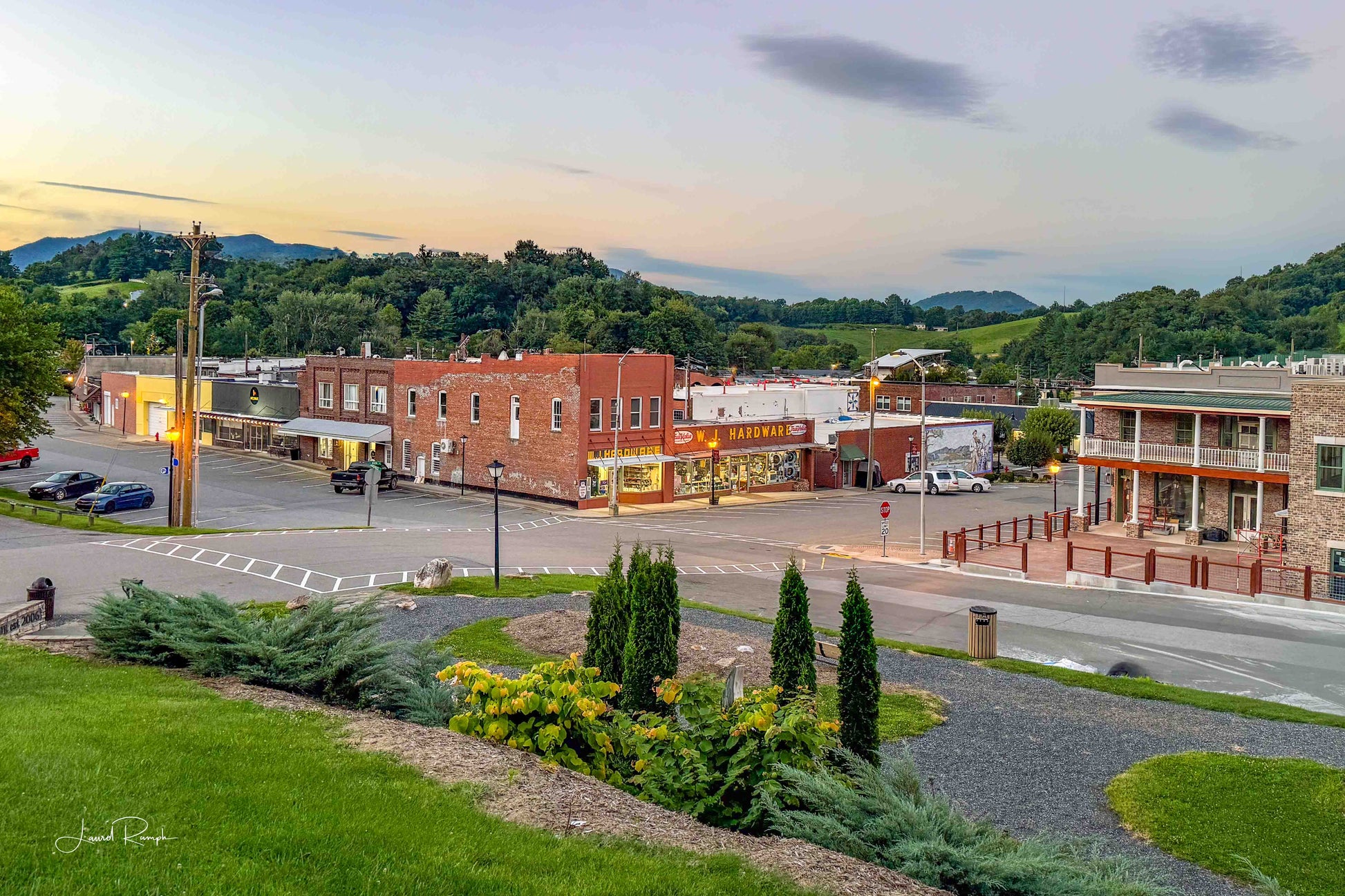 Summer evening shot of downtown west jefferson, North Carolina from the hill by the library, lots of yellow wildflowers match the yellow in the buildings, including west jefferson hardware and just wing it!