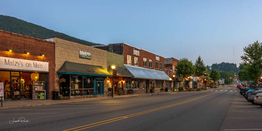 View of West Jefferson, North Carolina, just before sunrise, looking like a charming, small mountain town, with a mountain in the background.
