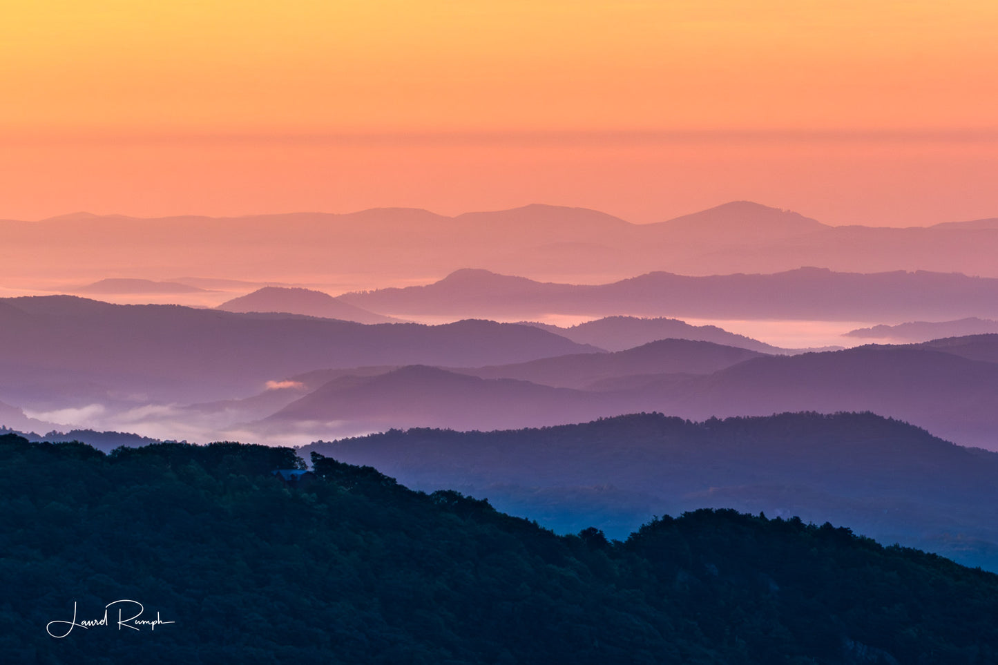 View from Thunder hill overlook near Blowing Rock, North Carolina, of iconic blue ridge mountains, but because of golden hour, mountains are orange and purple instead of blue and white. 2x3 crop