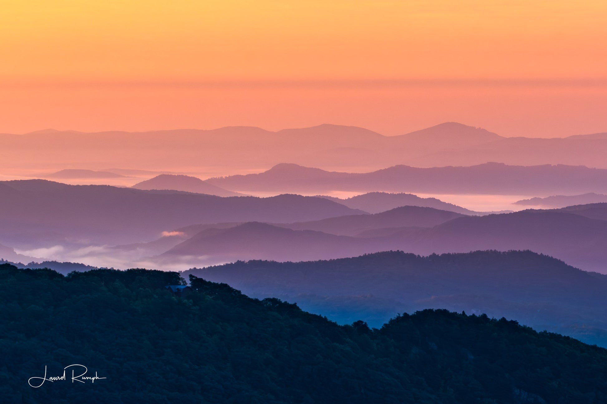 View from Thunder hill overlook near Blowing Rock, North Carolina, of iconic blue ridge mountains, but because of golden hour, mountains are orange and purple instead of blue and white. 2x3 crop